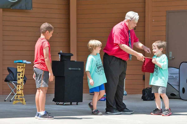 Magic Guy entertaining families at a Michigan festival
