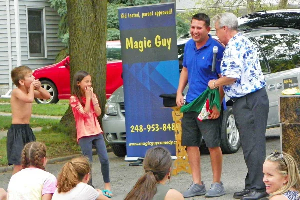 Magic Guy performing an outdoor comedy magic show for a crowd in Michigan